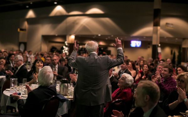 Kay Nasser with his arms raised at the C.J. Mackenzie Gala