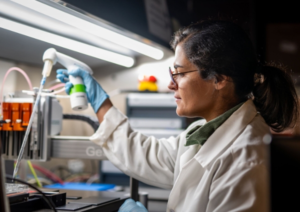 Female student in a lab looking at a sample.