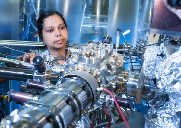 Female student at the synchrotron using equipment.