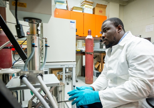 Male student using lab equipment.