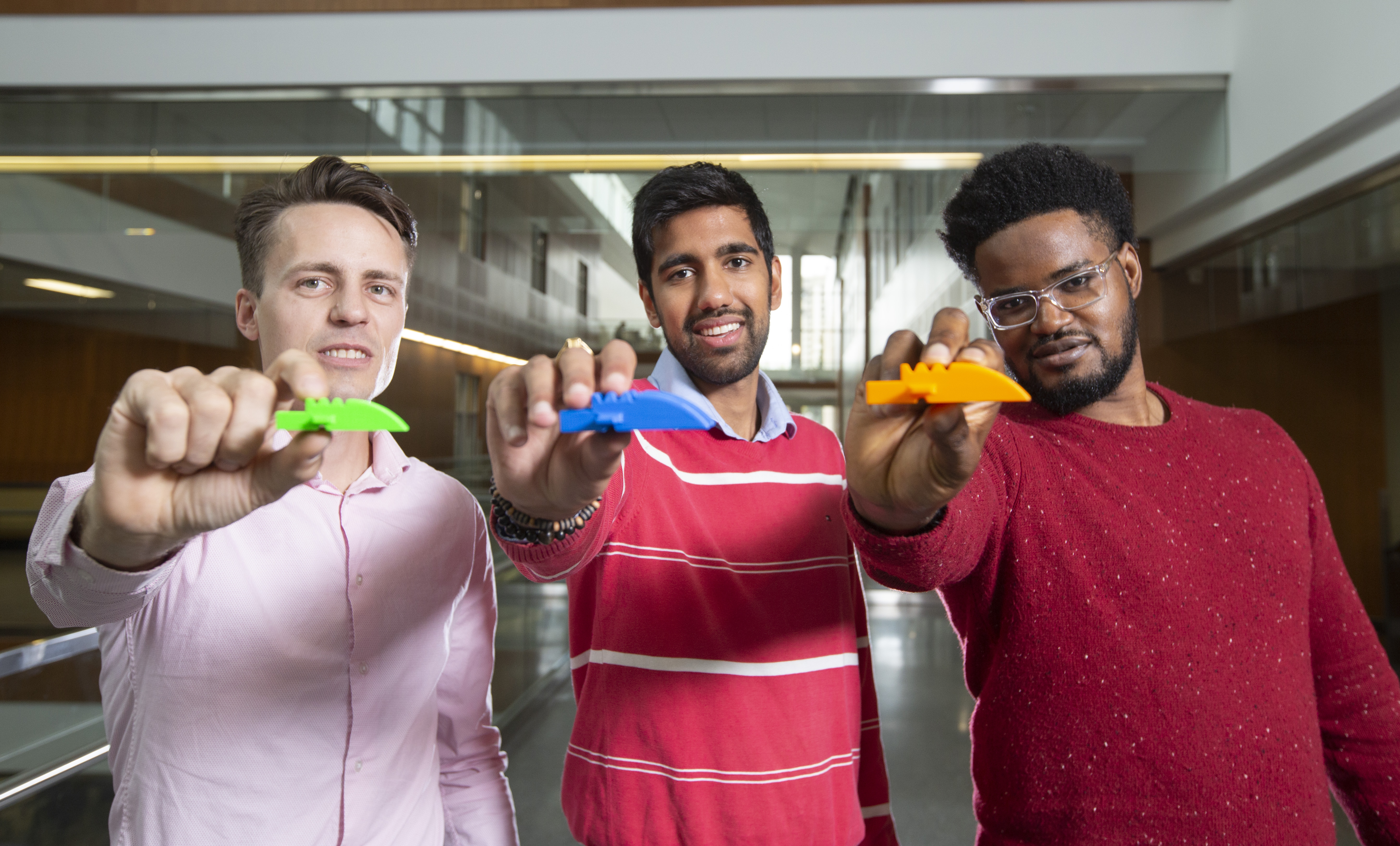 Soteria MedTech co-founders Cuylar Conly, Yash Shukla and Udoka Okpalauwaekwe hold a Lego-like airway device that could help save lives.