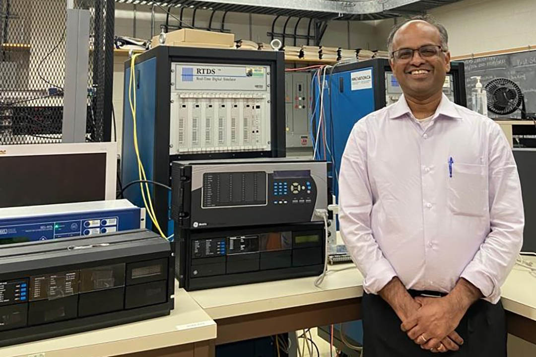 Professor Rama Gokaraju stands in a electrical and computer engineering laboratory