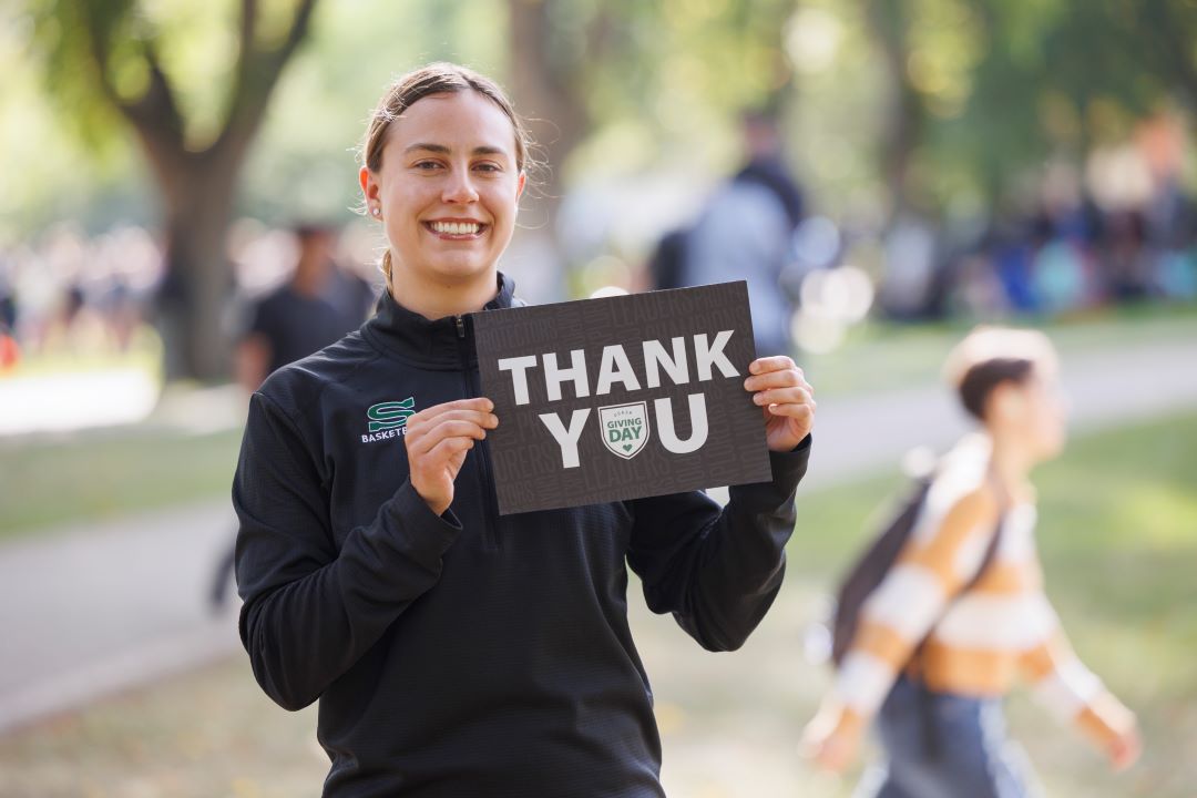 Young woman holding a thank you sign