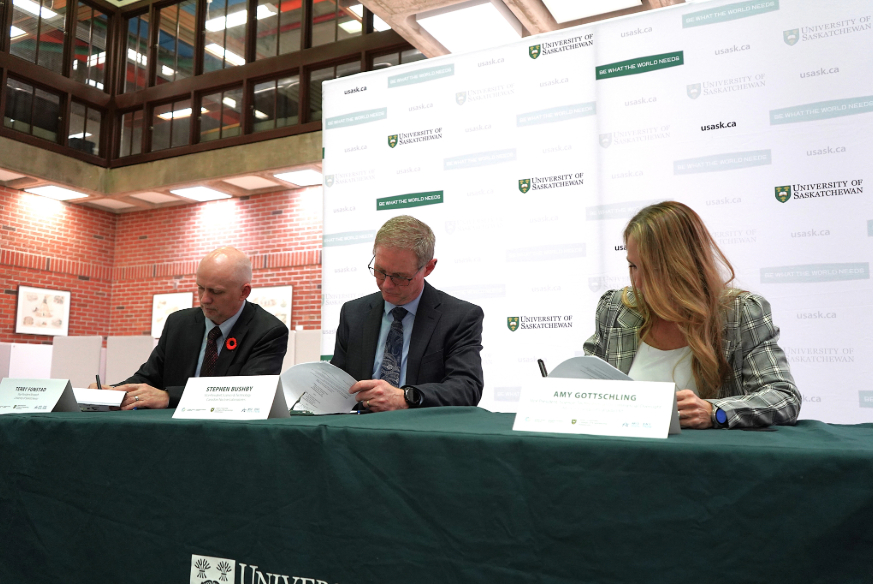 Pictured are USask Associate Vice President Research, Dr. Terry Fonstad, CNL Vice President Dr. Stephen Bushby and AECL Vice President, Amy Gottschling seated at a table, signing documents