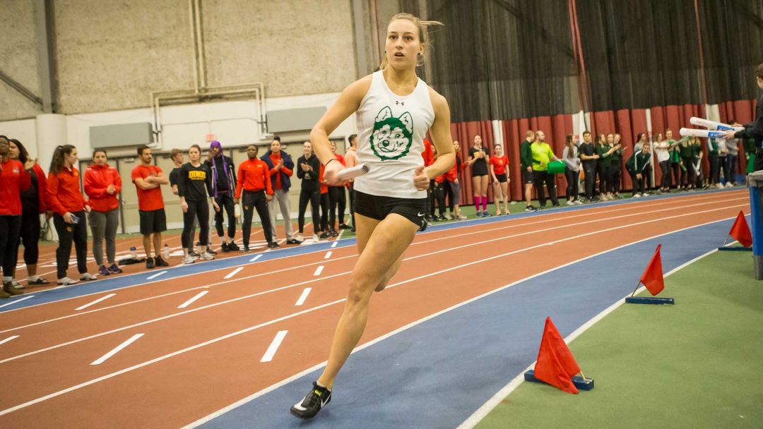 Kendra Farmer racing on an indoor track.