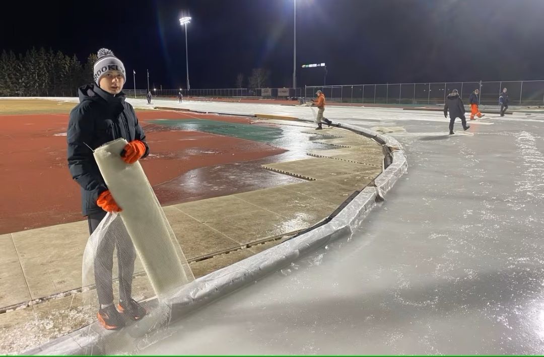 A young speed skater holds a roll of fibreglass mesh