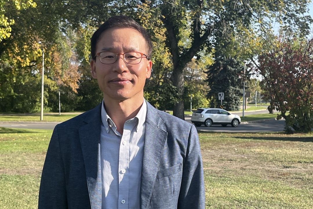 man standing on USask campus in sunny weather