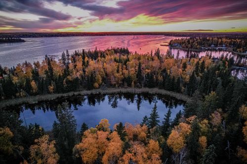Sunrise over a lake surrounded by trees